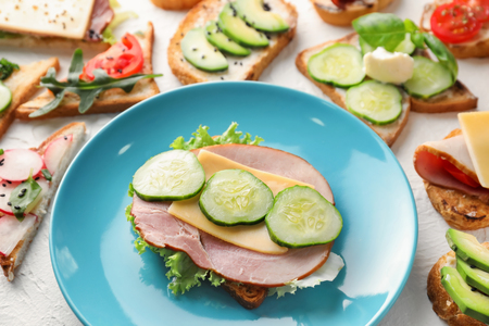Toasted bread with ham and cheese on plateの写真素材