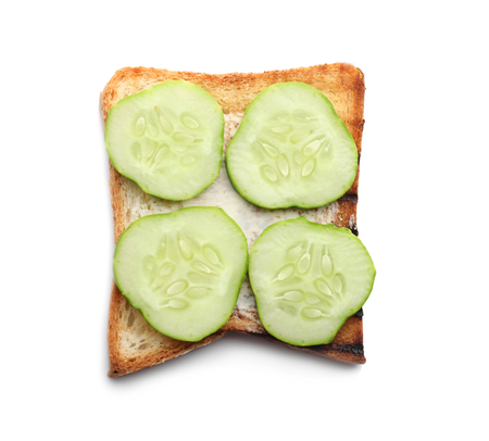 Toasted bread with cream cheese and cucumber on white backgroundの写真素材