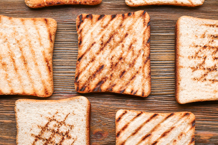Tasty toasted bread on wooden backgroundの写真素材