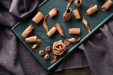 Delicious chocolate curls on boardの写真素材