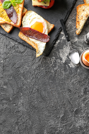 Composition with toasted bread and eggs on textured tableの写真素材