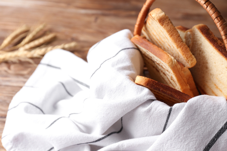 Wicker basket with toasted bread on tableの写真素材