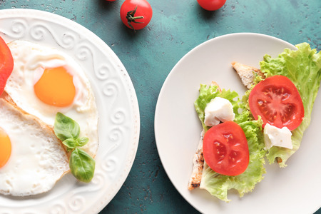 Composition of sandwiches with toasted bread and eggs on tableの写真素材