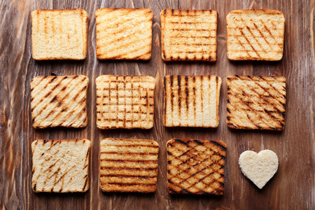 Tasty toasted bread on wooden backgroundの写真素材