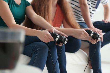 Young people playing video games at homeの写真素材
