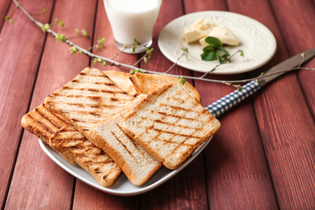 Plate with tasty toasted bread on tableの写真素材