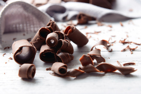 Chocolate curls on wooden tableの写真素材