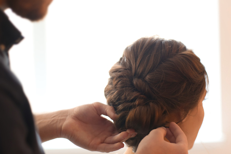 Professional hairdresser working with client in salonの写真素材