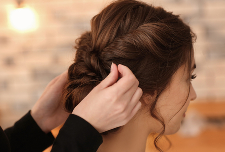 Professional hairdresser working with client in salonの写真素材