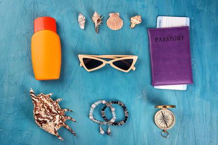 Composition with tourist's stuff on color background, top view