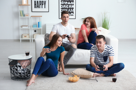 Young people playing video games at homeの写真素材