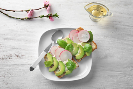 Plate with healthy toasts on white wooden tableの写真素材