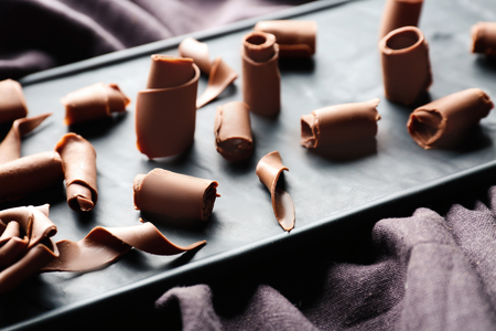 Delicious chocolate curls on boardの写真素材