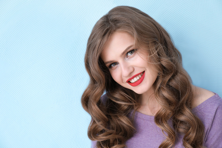 Beautiful young woman on color background