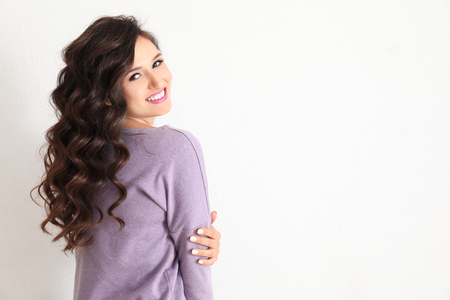 Portrait of beautiful young woman on light backgroundの写真素材