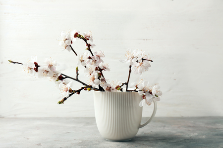 Vase with beautiful blossoming branches on tableの写真素材