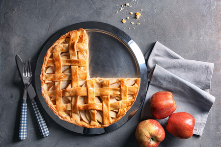 Plate with tasty homemade apple pie and fresh fruit on table, top viewの写真素材