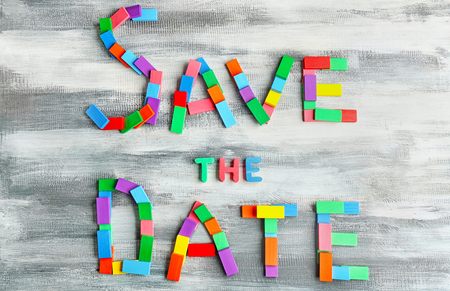 Phrase SAVE THE DATE composed with colorful blocks on wooden backgroundの写真素材