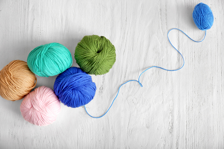 Colorful knitting yarn on wooden tableの写真素材
