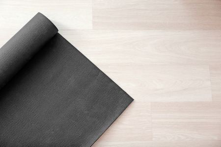 Yoga mat on wooden floorの写真素材