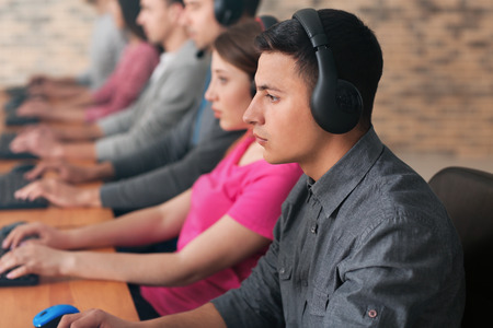 Young people playing video games at tournamentの写真素材