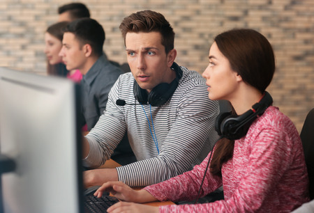 Young people playing video games at tournamentの写真素材