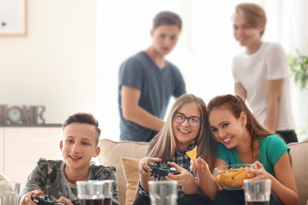 Teenagers playing video games at homeの写真素材