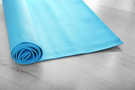 Yoga mat on wooden floorの写真素材