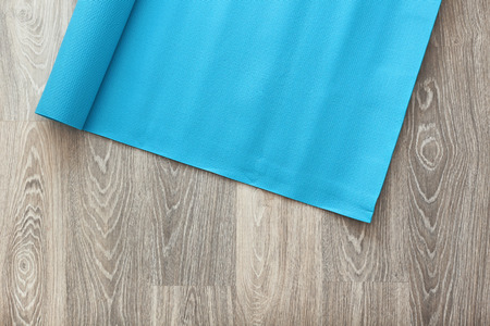 Yoga mat on wooden floorの写真素材