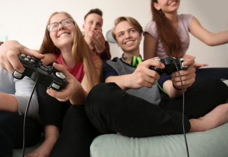 Teenagers playing video games at homeの写真素材