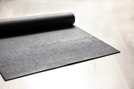 Yoga mat on wooden floorの写真素材