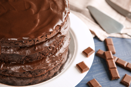 Plate with delicious chocolate cake on wooden tableの写真素材