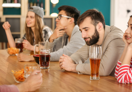 Group of friends drinking beer in barの写真素材