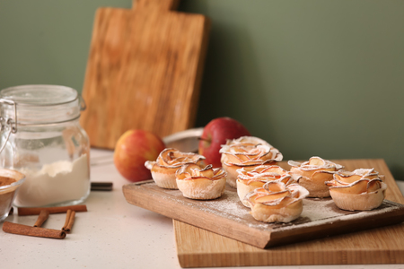 Tasty apple roses from puff pastry on kitchen tableの写真素材