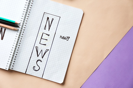 Notebook with words NEWS on color backgroundの写真素材