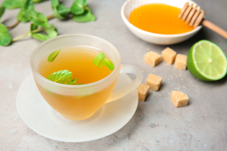 Cup of hot aromatic tea with mint on tableの写真素材
