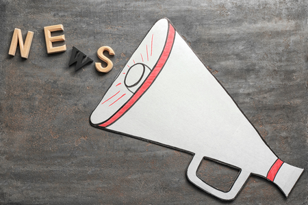 Word NEWS made with letters and megaphone on grey backgroundの写真素材