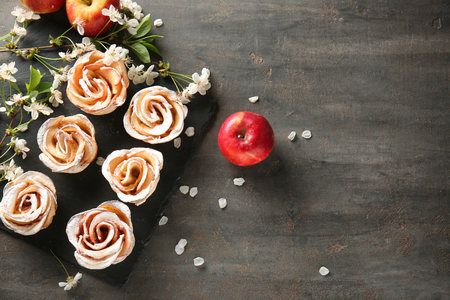Tasty apple roses from puff pastry on slate plateの写真素材