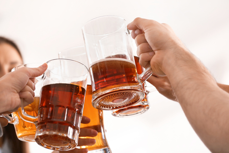 Group of friends clinking glasses with beer in barの写真素材