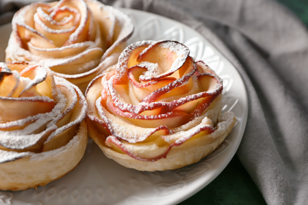 Plate with rose shaped apple pastry on table, closeupの写真素材