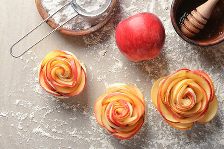 Raw rose shaped apple pastry on tableの写真素材