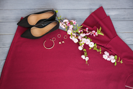 Set of trendy female clothes, accessories and blossoming branches on color background, flat layの写真素材