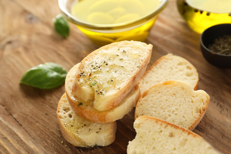Bread with olive oil and spices on wooden tableの写真素材