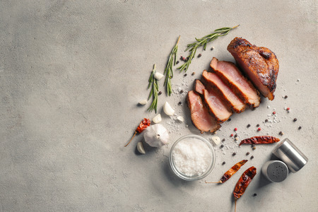 Sliced tasty steak with spices and salt on light backgroundの写真素材