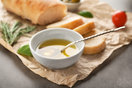 Bowl with olive oil on tableの写真素材