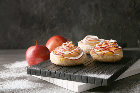 Tasty rose shaped apple pastry on wooden boardの写真素材