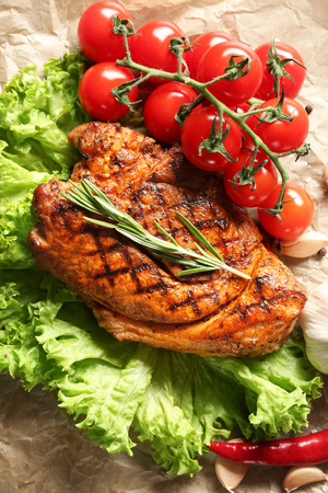 Tasty grilled steak with fresh vegetables on parchmentの写真素材