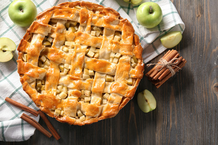 Composition with delicious apple pie on wooden tableの写真素材