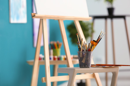 Tools and paints of professional artist on table in workshopの写真素材
