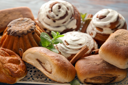 Sweet cinnamon buns on tray, closeupの写真素材